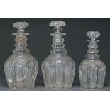 A fine pair of late Regency triple ring neck glass decanters and a half bottle decanter en suite,