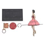 A lithographed tinplate friction powered dancing ballerina toy, c1930, a black glass commemorative