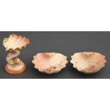 A Royal Worcester shell on dolphin pin tray and pair of shell shaped dishes, 1897 and circa, the