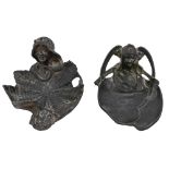 Two art nouveau pewter pin trays in the form of the head of a young woman issuing from a lily or