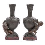A pair of French fin de siecle bronzed spelter cherub vases, c1900, cast from a model by Auguste