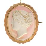 A cameo brooch, the oval white coral carved with the head of a bacchante, 40mm, marked 9ct Fine