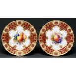 A pair of Royal Worcester dessert plates, 1911, painted by F Roberts, both signed, with fruit in