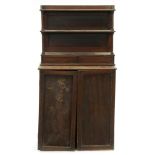 A Regency mahogany bookcase, fitted with adjustable shelves enclosed by panelled doors, the sides