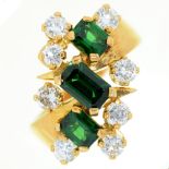 An emerald and diamond ring, with three step cut emeralds, in gold marked 18, 8.5g, size L Good
