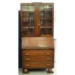 An oak bureau-cabinet, c1930, 198cm h; 43 x 91cm Good condition
