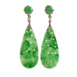 A pair of jadeite earrings, c1930, of tear drop form carved and pierced with fruit and foliage,