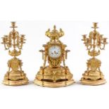 An ormolu garniture de cheminee, 19th c, the ornate case with urn finial with bird handles and