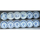 A set of eight Chinese export blue and white  plates, late 18th c, painted with a flower filled