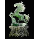 A Chinese jade carving of a prancing horse, 18cm h, carved stone stand Good condition