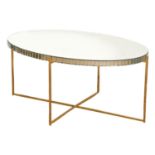 An oval  glass topped, polished metal coffee table