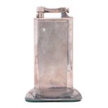 An Alfred Dunhill silver plated table lighter, engine turned, 10cm h Good condition. Little sign