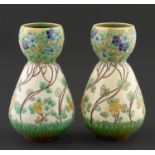 Art pottery. A pair of Burmantofts garlic necked vases, c1900, moulded with a repeating design of