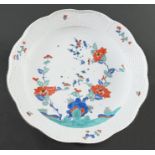 A Meissen Kakiemon dish, c1735, enamelled with flowering plants, the largest sprouting from a blue
