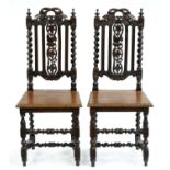 A pair of Victorian carved and dark stained oak side chairs