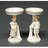 A pair of Royal Worcester single boy and girl early English comports, 1883, designed by James Hadley