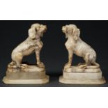 A pair of alabaster sculptures of seated dogs, 19th c, on stepped base, 17cm h Fore leg of one dog