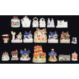 Eighteen various Staffordshire and Continental pottery and porcelain cottage and other banks,