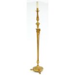 A gilt lacquered brass standard lamp, 20th c, in neo classical style, on three paw feet, 132cm h
