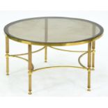 A circular lacquered brass table, late 20th cm, with smoke glass top, 41cm h, 76cm diam Good
