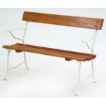 A garden seat,  with rustic cast iron ends and varnished lightwood slats, 82cm h, 122cm l Good