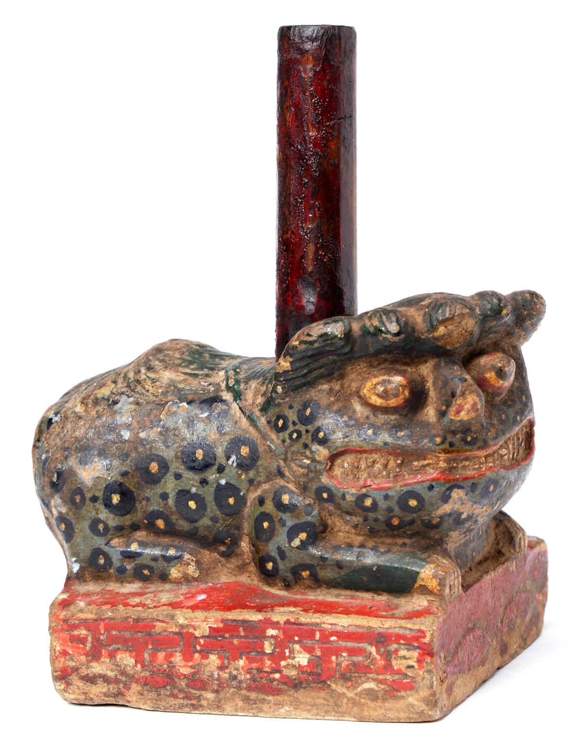 A South East Asian polychrome stone recumbent beast temple guardian, 19th c, 12cm h excluding wood