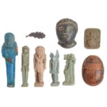 Antiquities. An  ancient Egyptian turquoise faience ushabti, 6.4cm l, four similar faience figural
