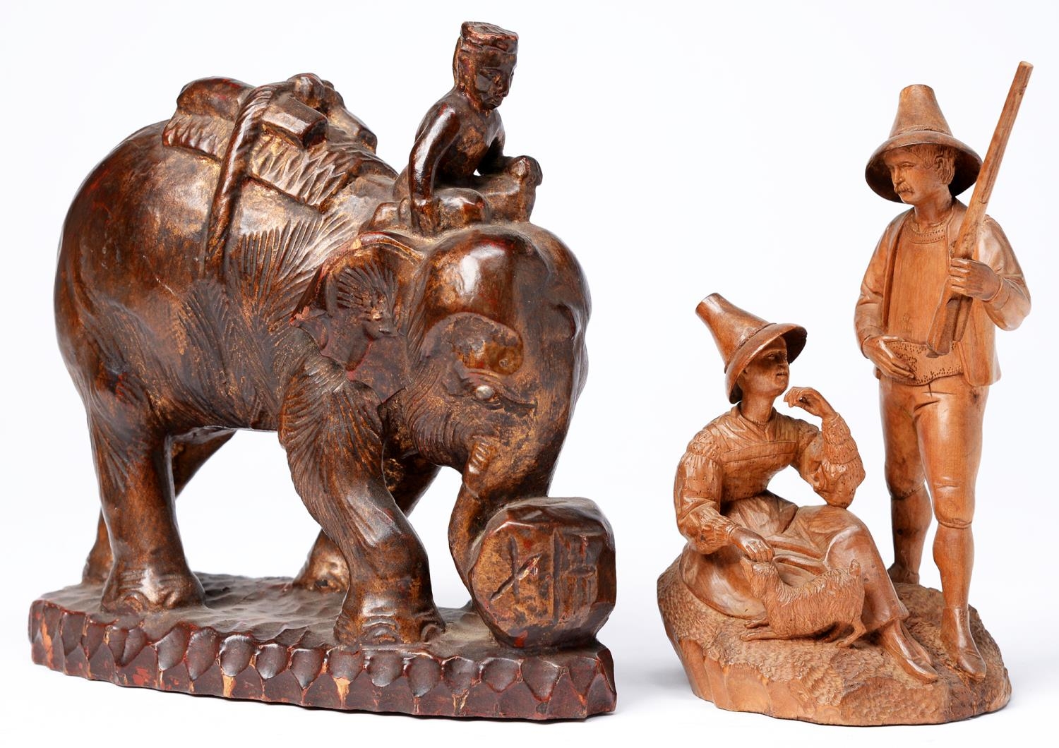 A South East Asian carved wood sculpture of an elephant with mahout, early 20th c,  20ct h and a