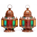 A pair of orientalist pierced metal and polychrome glass hanging lanterns, of recent manufacture,