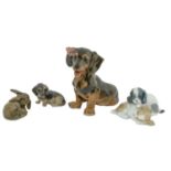 Three Royal Copenhagen porcelain models of dogs and one other, 19cm h and smaller, printed marks