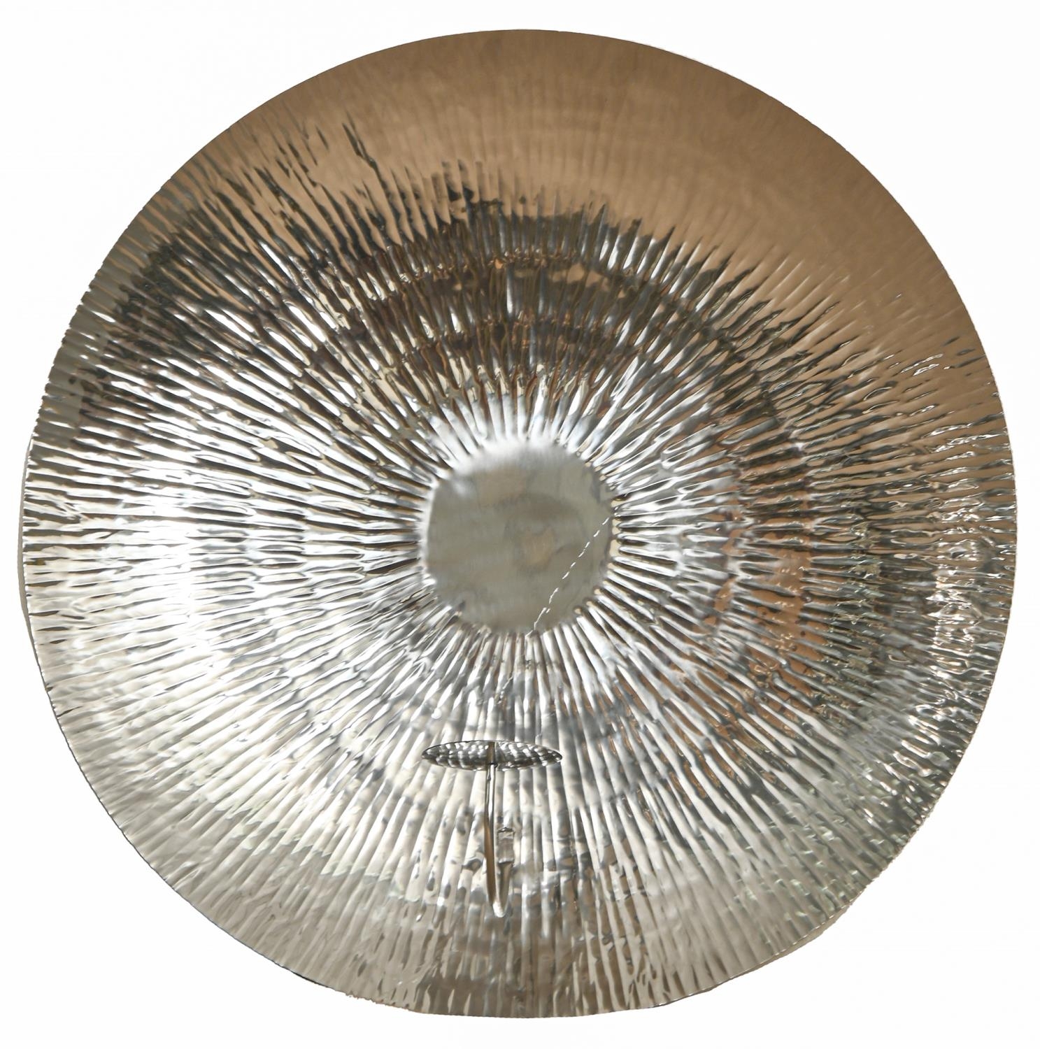 A silvered metal wall sconce with textured parabolic reflector