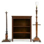 A carved oak open bookcase, 116cm h; 28 x 92cm and two carved or turned walnut or oak standard lamps