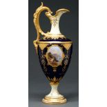 A Coalport ewer, c1900, painted with an oval medallion of a lake scene, in raised gilt surround