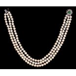 A cultured pearl necklace, of three rows of 7mm cultured pearls with diamond and emerald cabochon