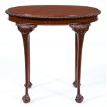 A mahogany occasional table, early 20th c, the gadrooned oval top on carved cabriole legs and claw