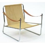 A chromium plated tubular steel chair, with tan hide sling arms, c1970 Condition evident from image,