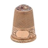 A Victorian gold thimble, with amethyst glass top and foliate engraved border, 22mm h, 4.5g Good
