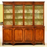 A mahogany breakfront bookcase, c1975, in George III style, the green painted interior with