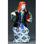 A Chinese  porcelain figure of a young woman, 20th c,  with long flowing red hair, her robe