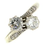 A diamond crossover ring, with diamond set shoulders in platinum marked PLAT, 3.6g, size O Hoop