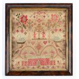 A Victorian linen sampler Hannah Hirst, worked with Adam & Eve, a red wall with door, chairs,