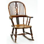 A Victorian yew wood Windsor chair, with elm seat and turned stretcher, on rockers Lower part of