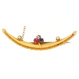 A diamond, ruby and sapphire crescent brooch, c1900, in gold, 50mm l, marked 15ct, 3g Good