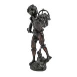 A bronze statuette of a youth with a basket of fruit over his shoulder,  uneven dark patina rubbed