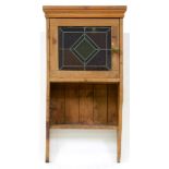 A pine hanging cupboard with leaded glass door, 98cm h; 26 x 50cm Undamaged but much dirt from