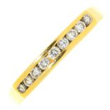 A nine stone diamond ring, channel set in 18ct gold, marks obscured, 2.8g, size N½ Light wear