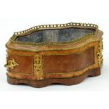A French tulipwood and amboya jardiniere,  late 19th c,  of serpentine form with giltmetal mounts,