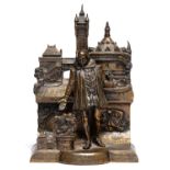 A brass statuette of William Shakespeare standing before the burning ruins of the memorial theatre