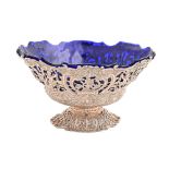 A Dutch cast openwork silver fruit bowl, chased with figures and flowers, on pierced foot, blue