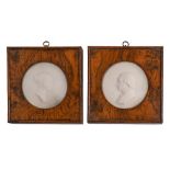 A pair of wax portrait medallions of a nobleman and lady, 19th c,  85mm diam, in square burr oak